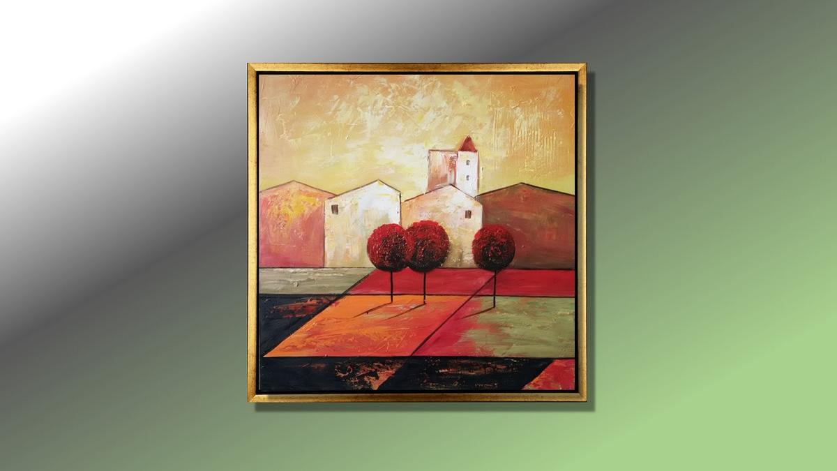Handgemaltes Ölbild mediterranes Dorf mit roten Bäumen auf Leinwand, warme Rot-, Orange- und Goldtöne, mit goldenem Rahmen – Beispiel im Raum