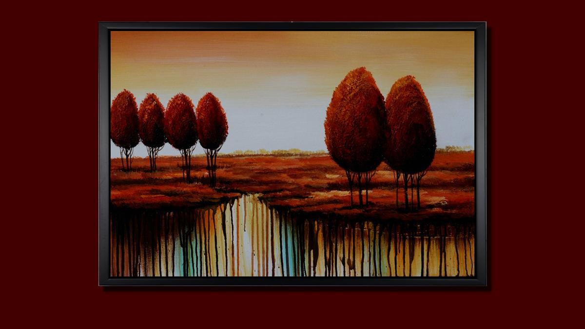 Handgemaltes Ölbild rote Bäume in weiter Landschaft auf Leinwand, modern mit Farbläufen in Rot und Türkis, mit schwarzem Rahmen – Beispiel im Raum
